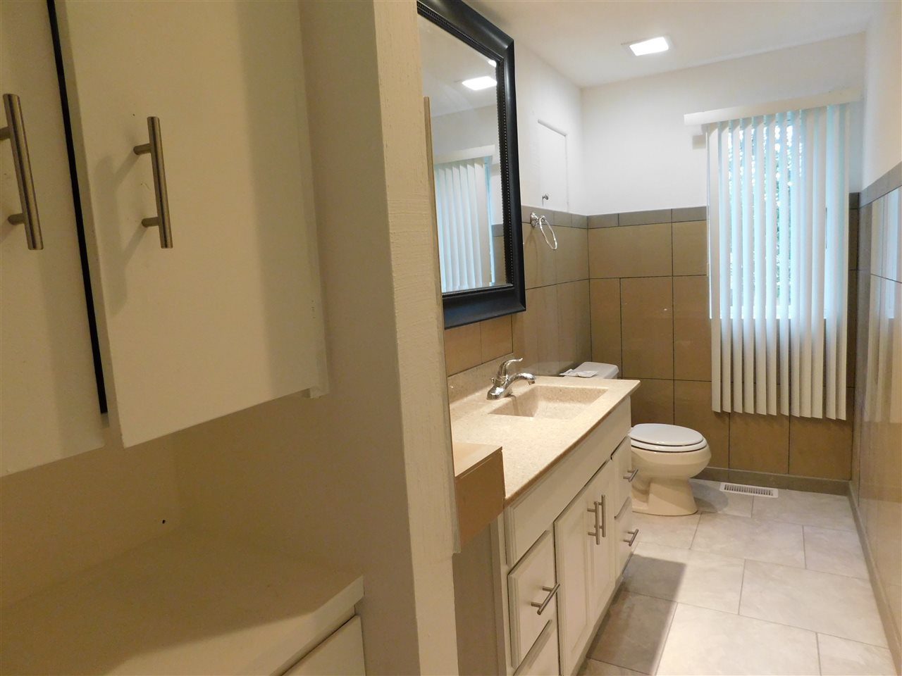 6309 Park Ridge Road Loves Park, IL 61111 - Photo 19 of 26 a bathroom with a granite countertop sink toilet and shower