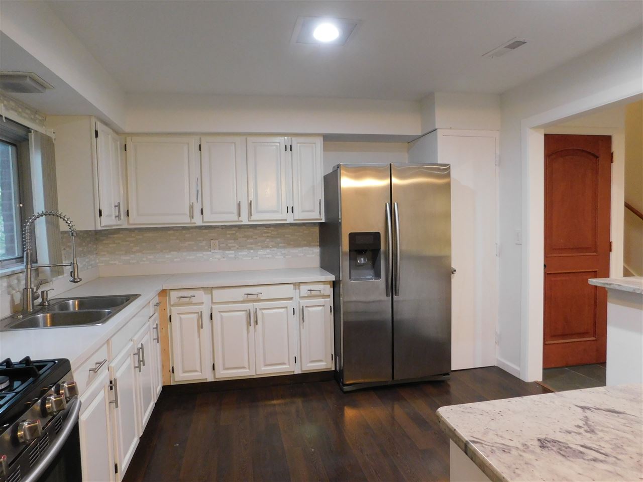 6309 Park Ridge Road Loves Park, IL 61111 - Photo 6 of 26 a kitchen with stainless steel appliances granite countertop a refrigerator a sink and white cabinets