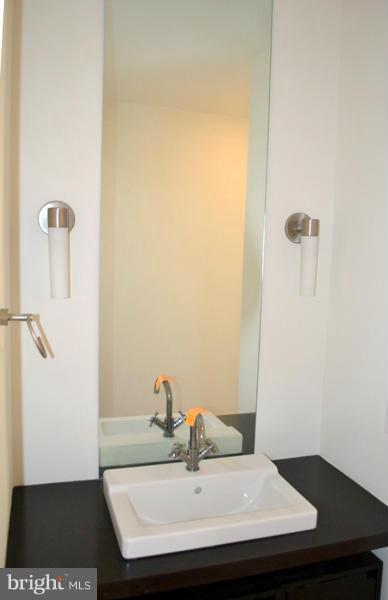 1018 North Charles Street, Unit R7 Baltimore, MD 21201 - Photo 9 of 13 a bathroom with a sink and a mirror