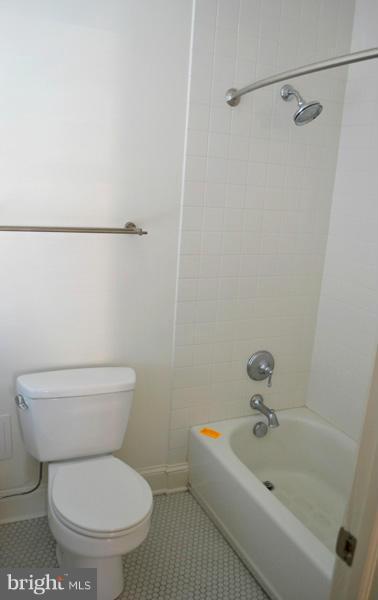 1018 North Charles Street, Unit R7 Baltimore, MD 21201 - Photo 10 of 13 a white toilet sitting next to a bathroom sink