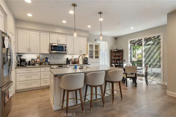a kitchen with kitchen island granite countertop wooden cabinets and stainless steel appliances