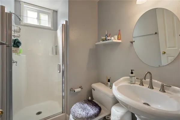 a bathroom with a sink toilet and shower