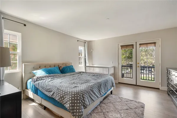 a bedroom with a bed a table and a window