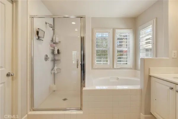 a bathroom with a bathtub and a shower