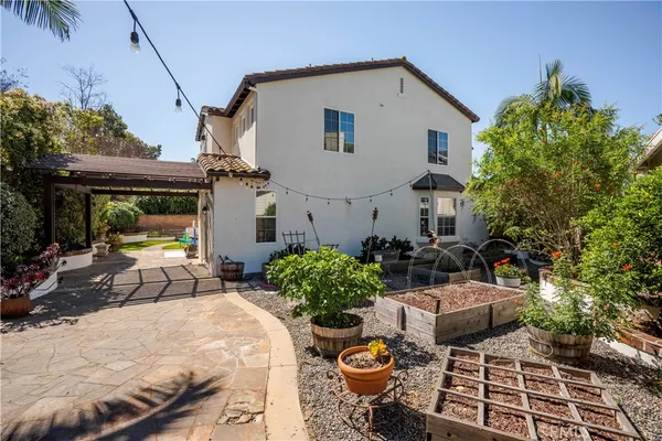 a view of a house with sitting area and potted plants