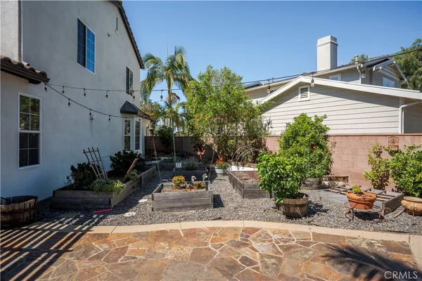a view of a backyard with sitting area and garden