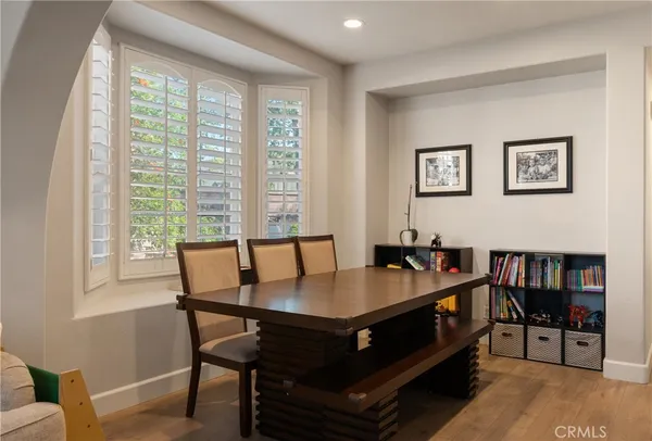 a room with a table and a bookshelf