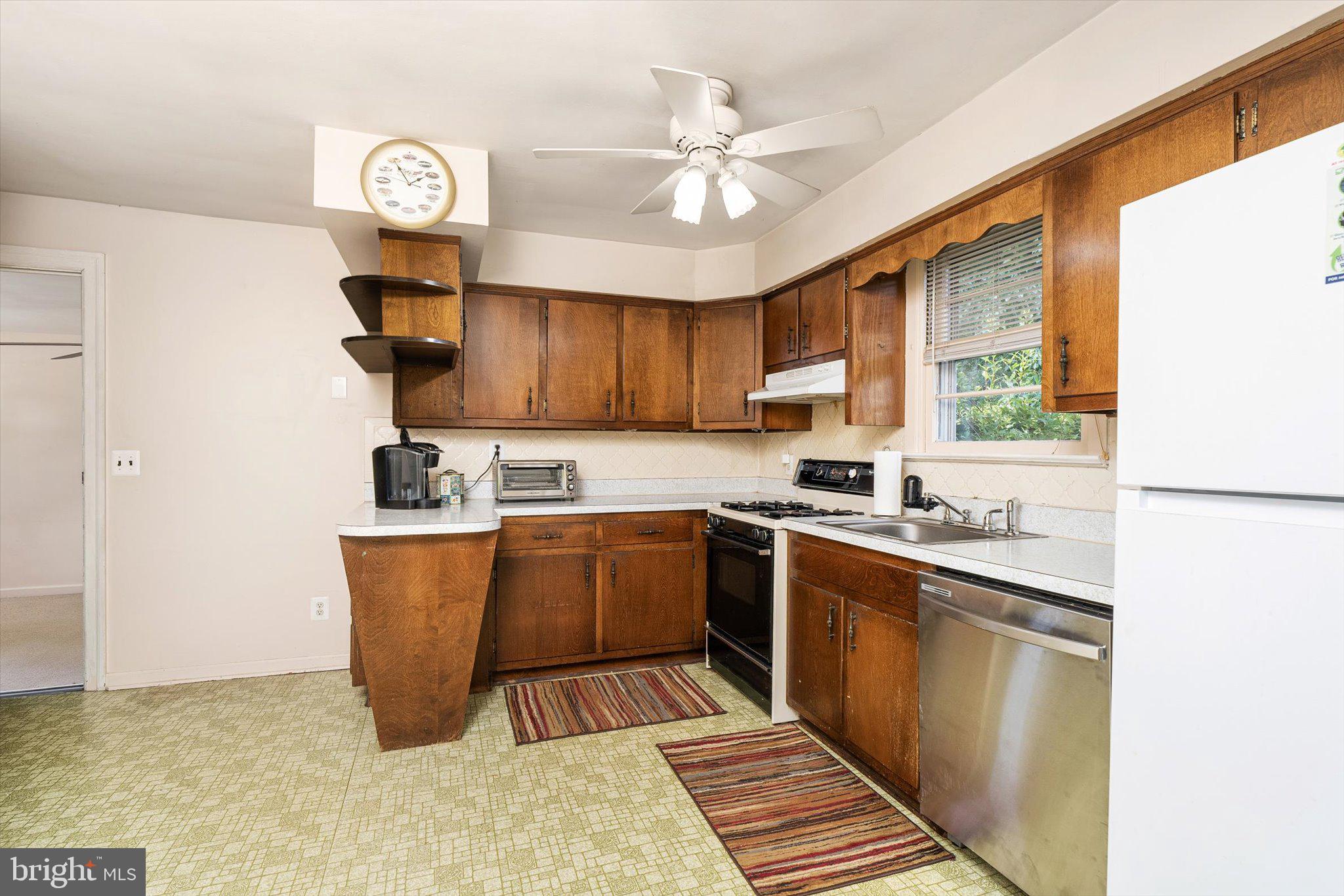 12 Fox Lane Hamilton, NJ 08620 - Photo 14 of 26 a kitchen with stainless steel appliances granite countertop a sink stove and refrigerator