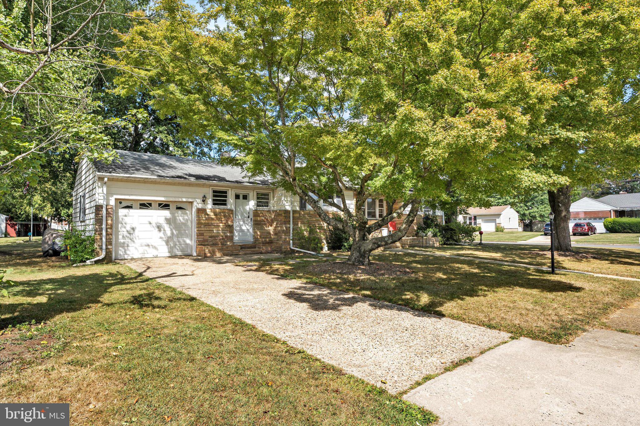 12 Fox Lane Hamilton, NJ 08620 - Photo 2 of 26 a front view of a house with a yard and garage