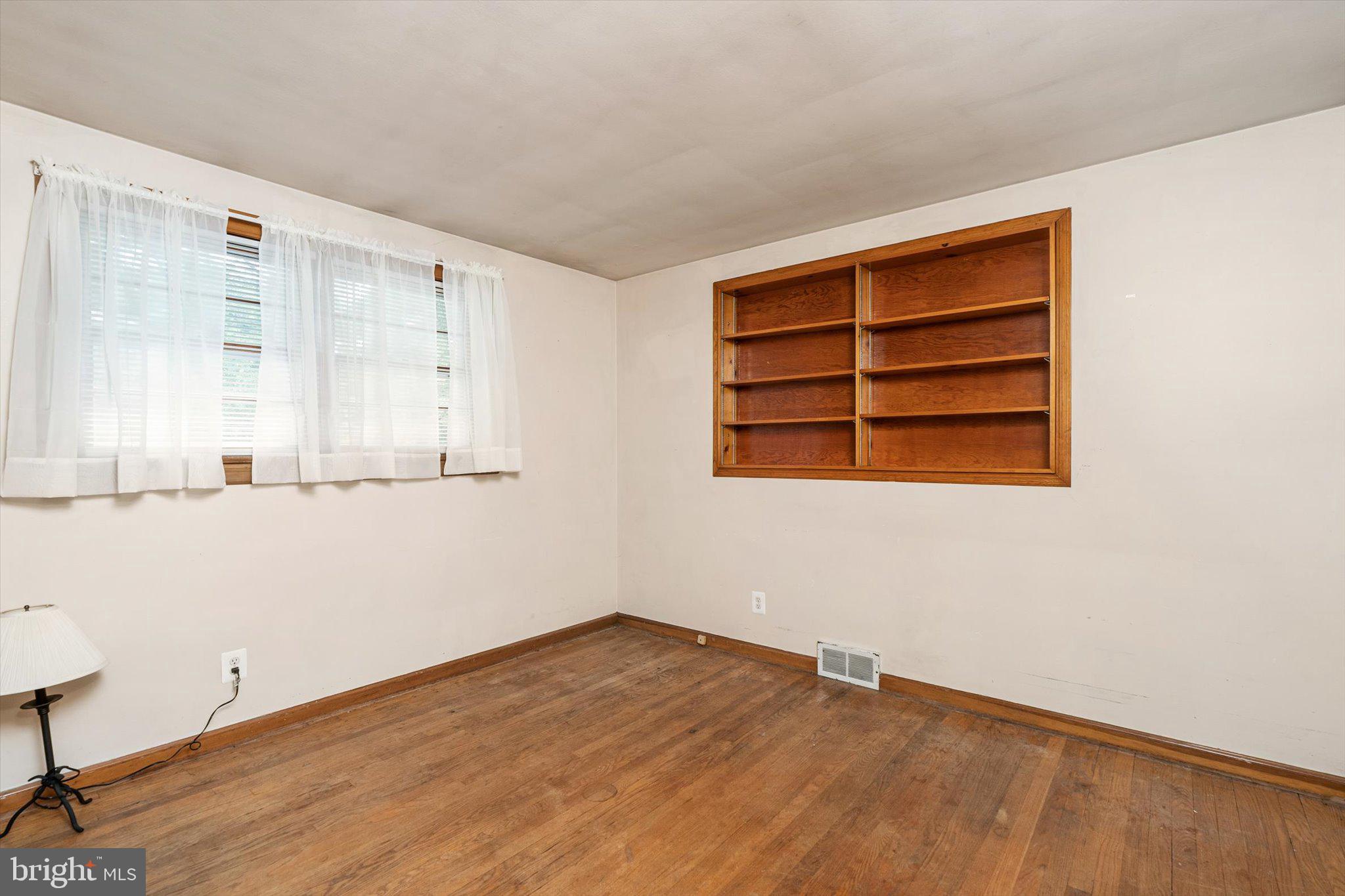 12 Fox Lane Hamilton, NJ 08620 - Photo 21 of 26 a view of an empty room with wooden floor and a window