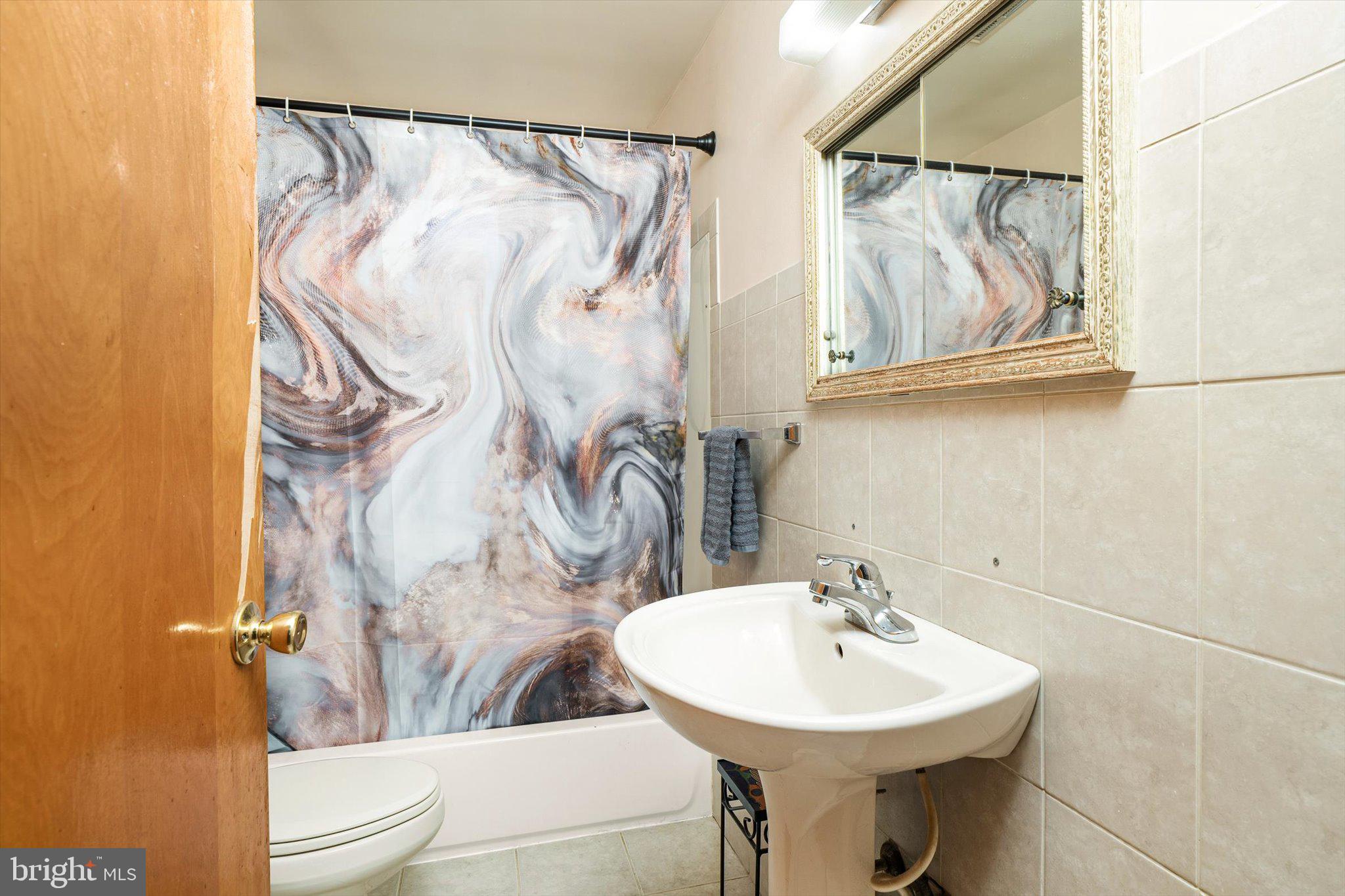 12 Fox Lane Hamilton, NJ 08620 - Photo 23 of 26 a bathroom with a sink and mirror with toilet
