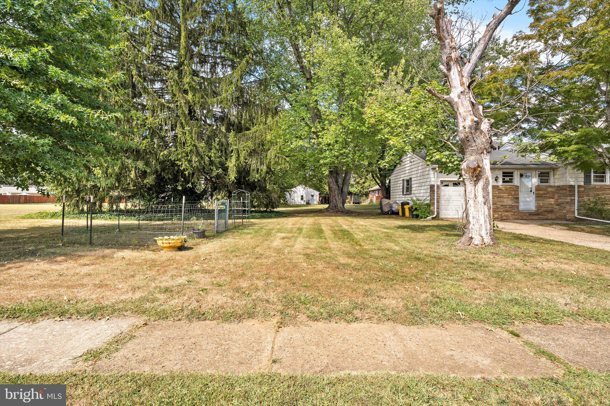 12 Fox Lane Hamilton, NJ 08620 - Photo 9 of 26 a swimming pool with trees in the background