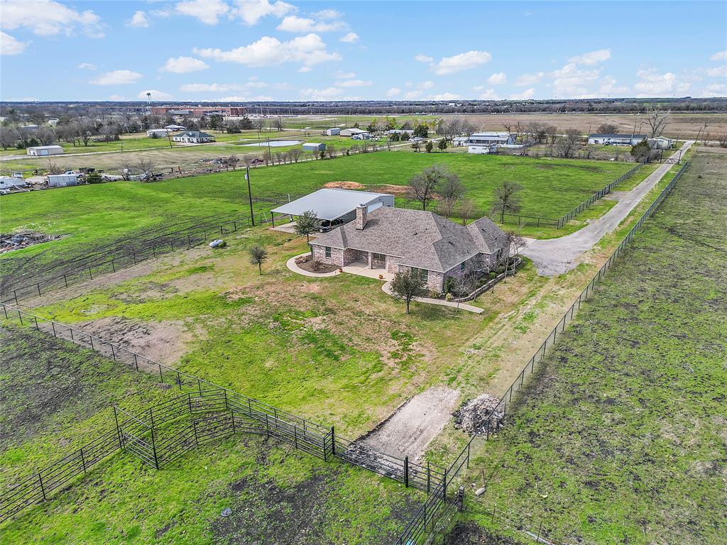 an aerial view of a house with a garden and mountain view