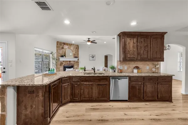 a kitchen with stainless steel appliances granite countertop a sink and cabinets