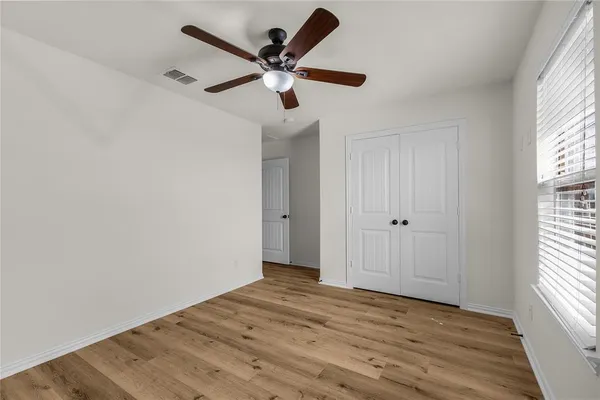 wooden floor in an empty room with a window