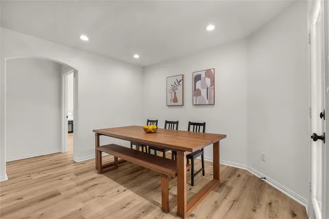 a room with furniture pool table and wooden floor