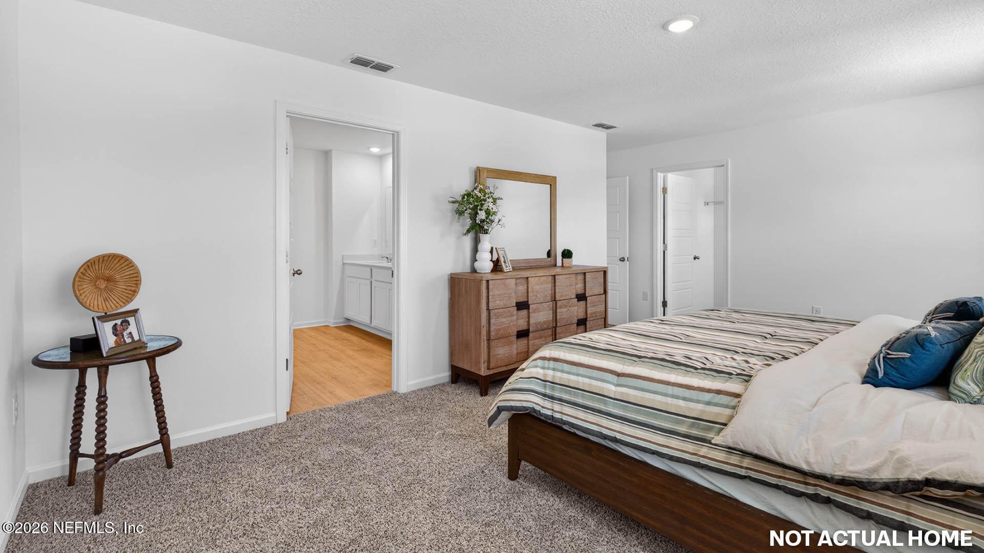 12095 Yew Tree Road Jacksonville, FL 32218 - Photo 17 of 61 a bedroom with a bed and a chandelier