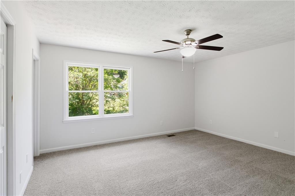 79 Cross Creek Court Villa Rica, GA 30180 - Photo 12 of 27 an empty room with a window and a fan