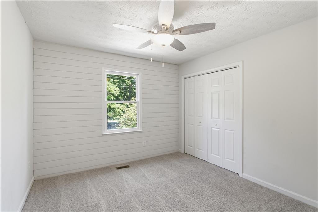 79 Cross Creek Court Villa Rica, GA 30180 - Photo 13 of 27 an empty room with windows and fan
