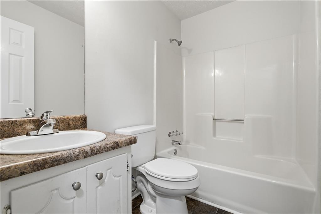 79 Cross Creek Court Villa Rica, GA 30180 - Photo 18 of 27 a bathroom with a granite countertop sink mirror vanity and toilet