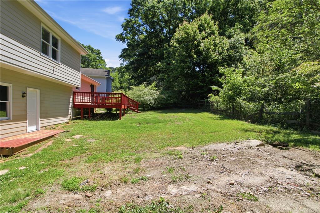 79 Cross Creek Court Villa Rica, GA 30180 - Photo 26 of 27 a view of a yard with plants and a bench