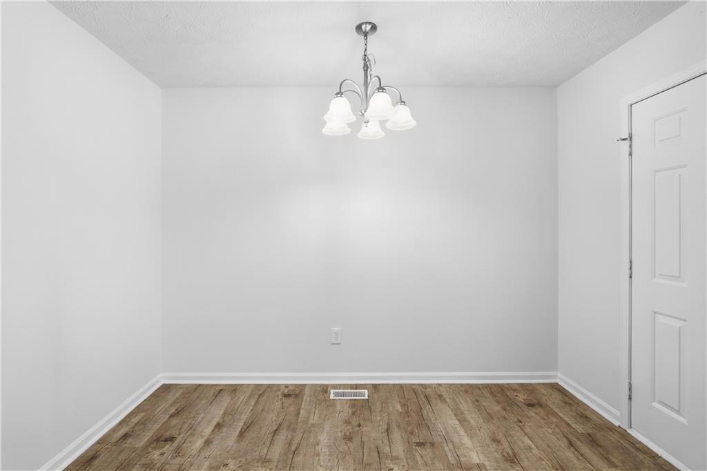 79 Cross Creek Court Villa Rica, GA 30180 - Photo 10 of 27 a view of a room with wooden floor and white walls