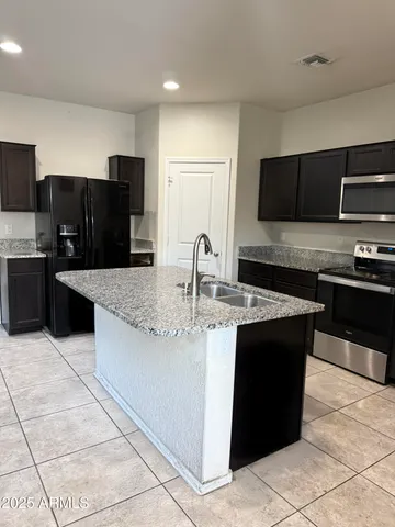 a kitchen with stainless steel appliances granite countertop a sink and a stove