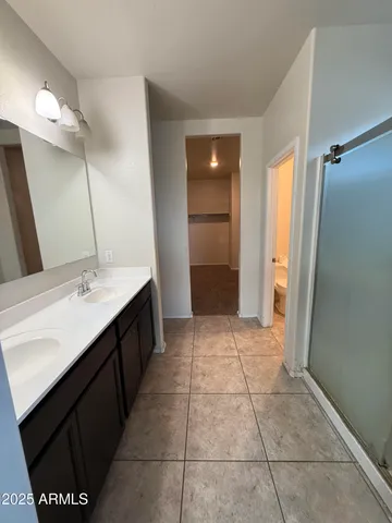 a bathroom with a sink a mirror and a shower