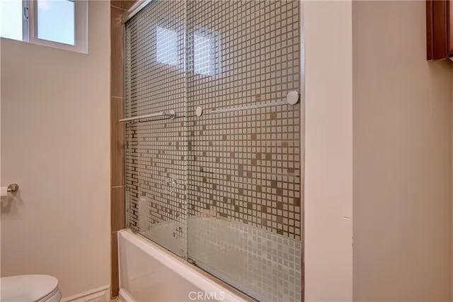a bathroom with a shower and a toilet