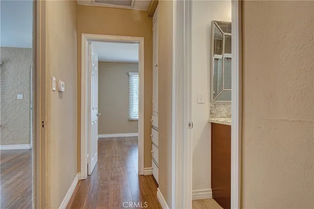a view of a hallway with wooden floor