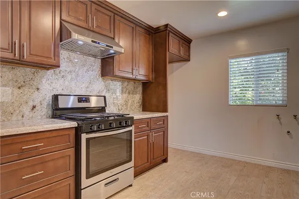 a kitchen with stainless steel appliances granite countertop a stove and a microwave