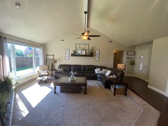 a living room with furniture a window and a table
