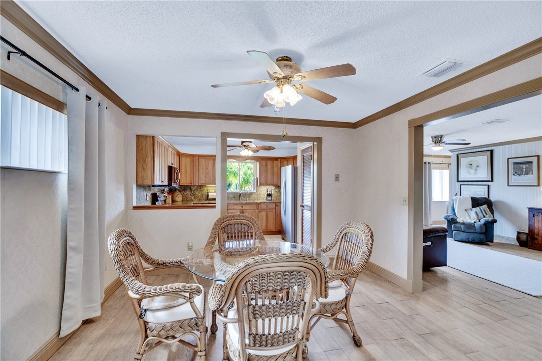 7666 134th Street Sebastian, FL 32958 - Photo 22 of 35 a view of a dining room with furniture window and wooden floor
