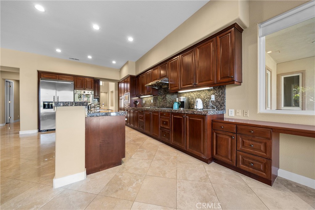 17 Oakmont Drive Rancho Mirage, CA 92270 - Photo 8 of 27 a kitchen with stainless steel appliances granite countertop a stove refrigerator and cabinets