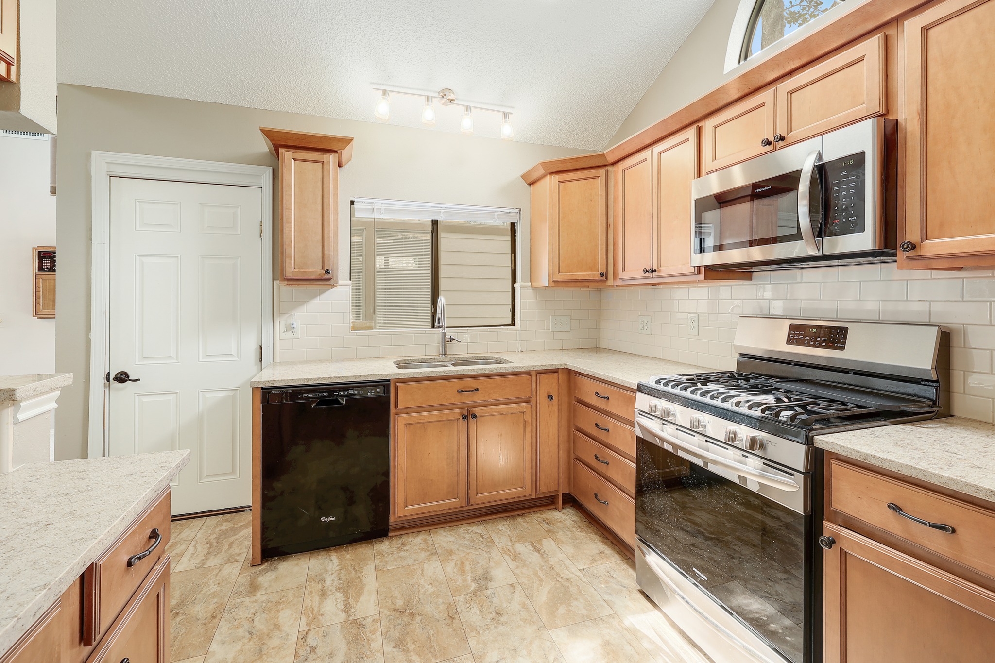 2202 Warfield Way Austin, TX 78728 - Photo 12 of 32 A well-equipped kitchen features ample cabinetry, durable countertops, and sleek stainless steel appliances.