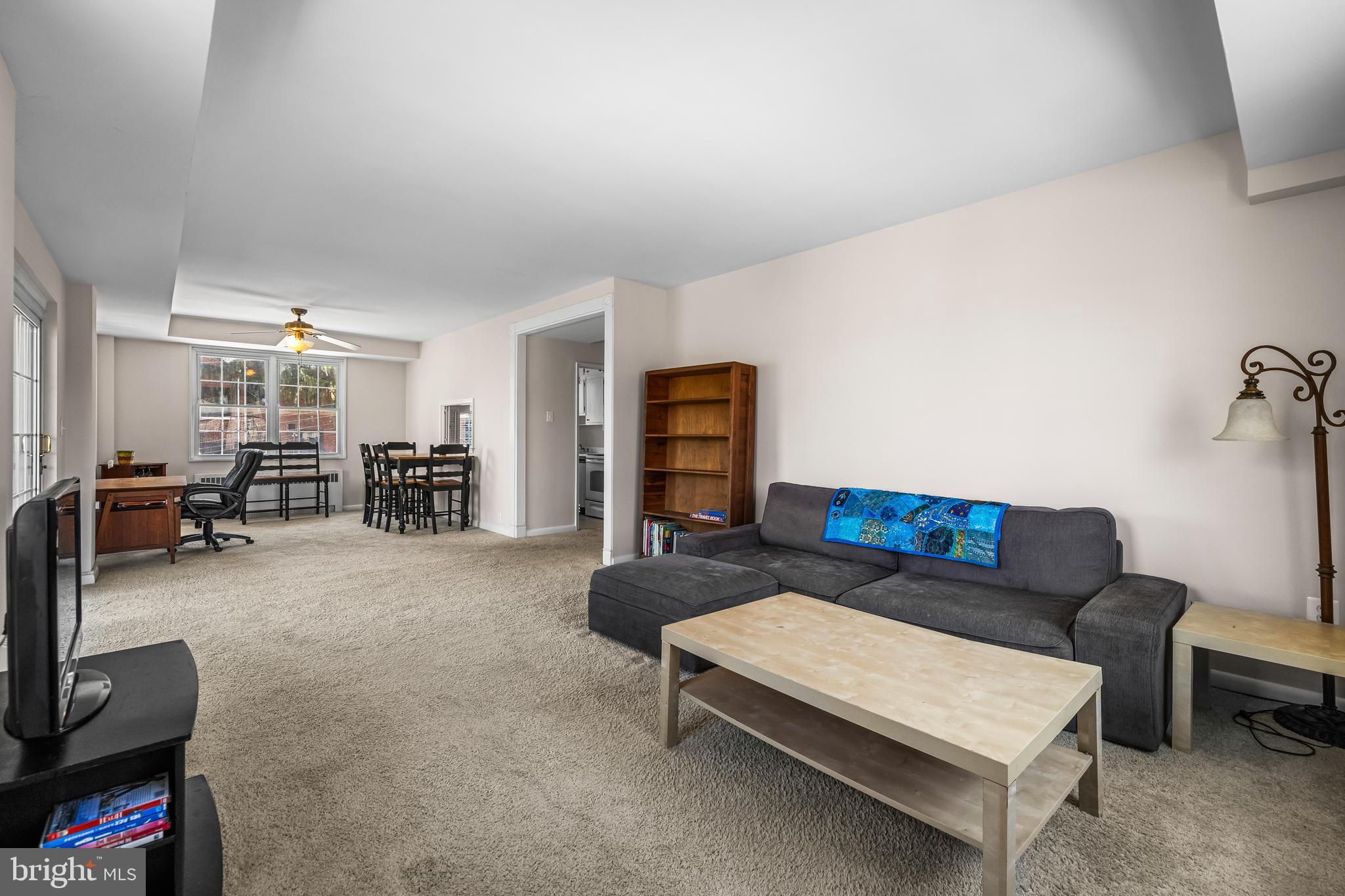 310 Ridgemede Road, Unit 307 Baltimore, MD 21210 - Photo 17 of 24 a living room with furniture and a flat screen tv