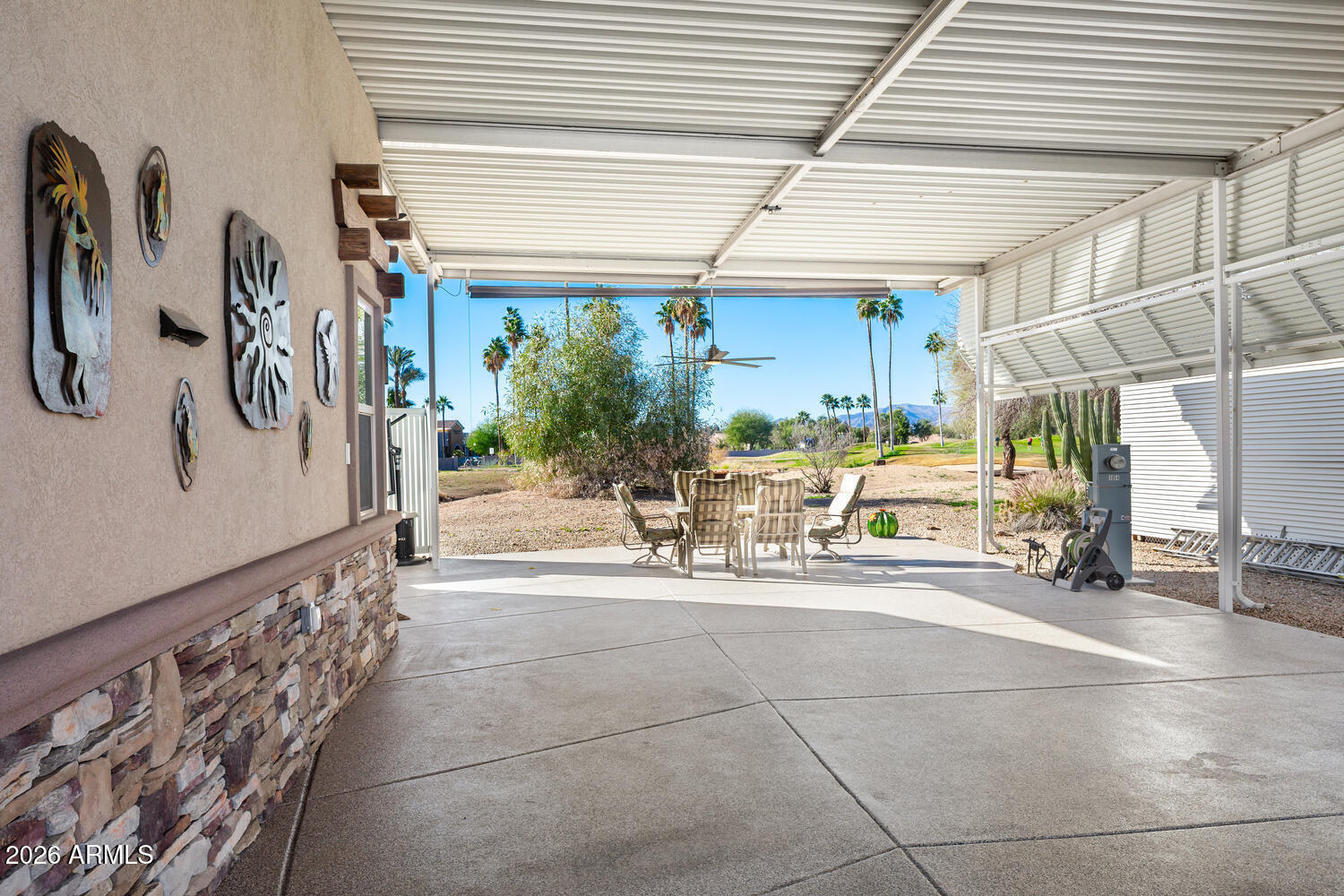 17200 West Bell Road, Unit 1054 Surprise, AZ 85374 - Photo 12 of 46 a view of a patio with table and chairs potted plants
