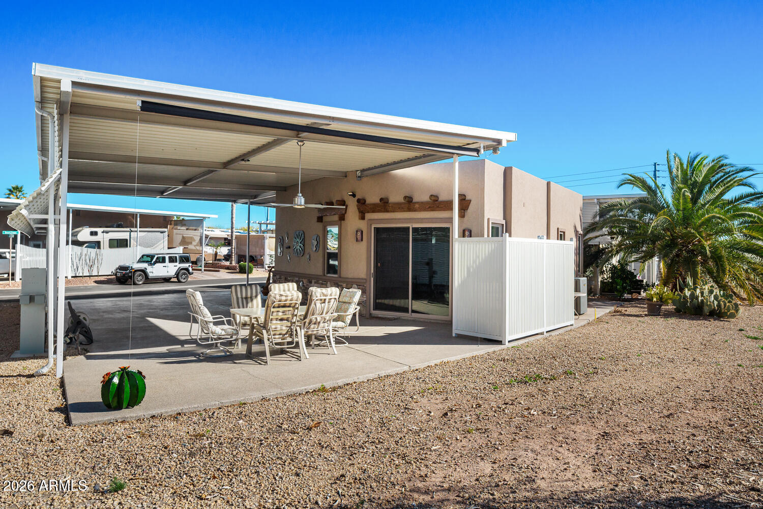 17200 West Bell Road, Unit 1054 Surprise, AZ 85374 - Photo 14 of 46 a view of a patio with table and chairs potted plants and floor to ceiling window