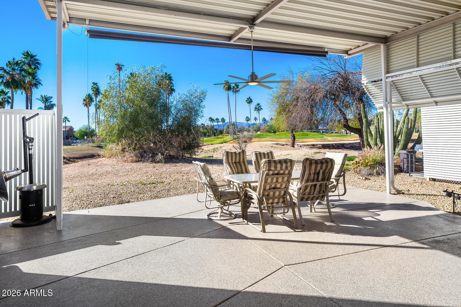 17200 West Bell Road, Unit 1054 Surprise, AZ 85374 - Photo 16 of 46 a view of a patio with table and chairs potted plants