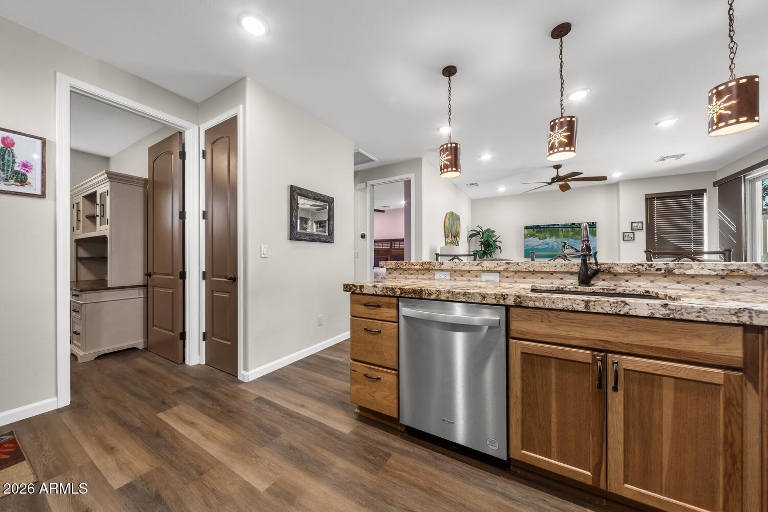 17200 West Bell Road, Unit 1054 Surprise, AZ 85374 - Photo 22 of 46 a kitchen with stainless steel appliances granite countertop a sink a stove a refrigerator and island with wooden floor
