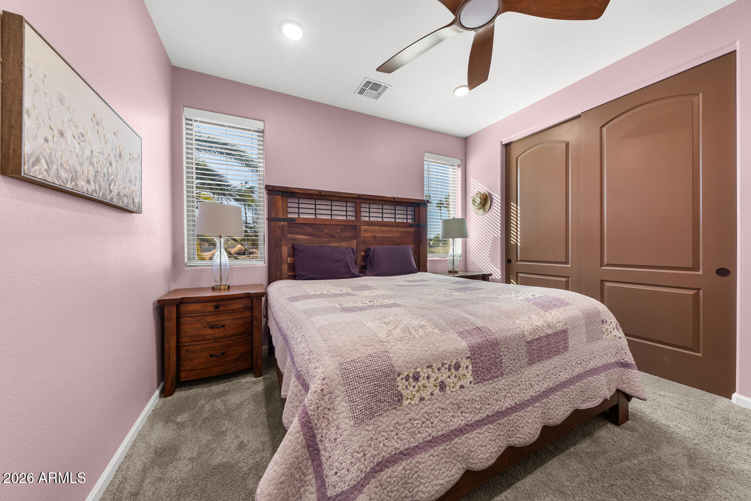 17200 West Bell Road, Unit 1054 Surprise, AZ 85374 - Photo 25 of 46 a bedroom with a bed and dresser with mirror