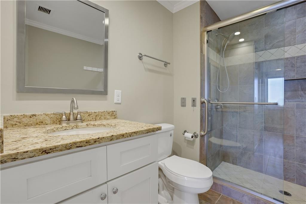 300 Johnson Ferry Road, Unit B902 Atlanta, GA 30328 - Photo 21 of 37 a bathroom with a granite countertop sink toilet and shower