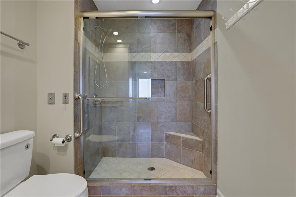 300 Johnson Ferry Road, Unit B902 Atlanta, GA 30328 - Photo 23 of 37 a bathroom with a shower and toilet