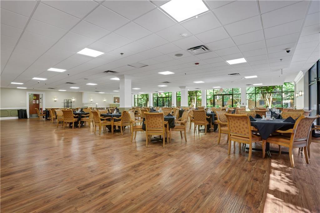 300 Johnson Ferry Road, Unit B902 Atlanta, GA 30328 - Photo 27 of 37 a group of dining room with lots of furniture and wooden floor