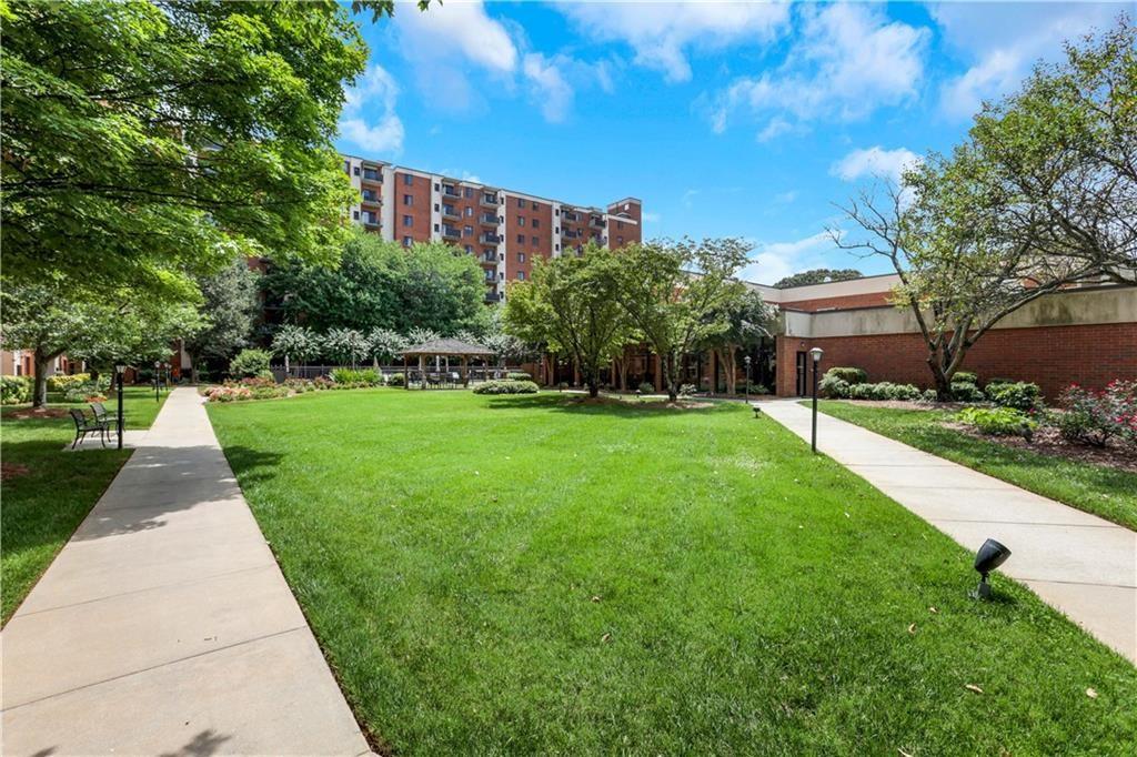 300 Johnson Ferry Road, Unit B902 Atlanta, GA 30328 - Photo 37 of 37 a front view of a building with a yard