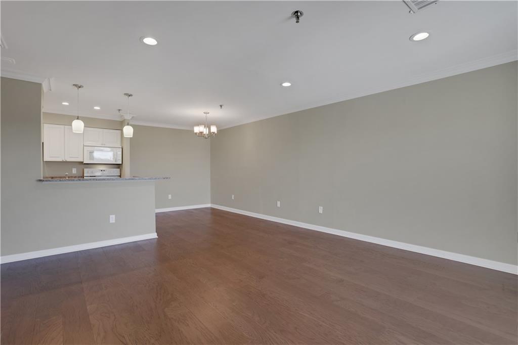 300 Johnson Ferry Road, Unit B902 Atlanta, GA 30328 - Photo 8 of 37 an empty room with wooden floor and windows