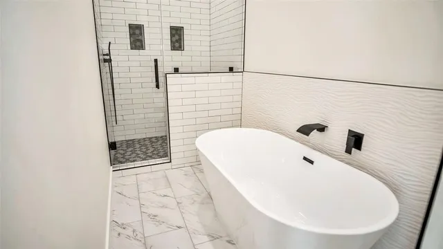 a bathroom with a bathtub and shower