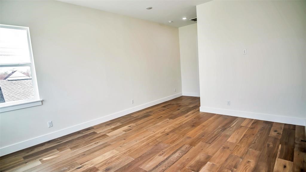1508 Weiss Street Houston, TX 77009 - Photo 9 of 16 an empty room with wooden floor and windows