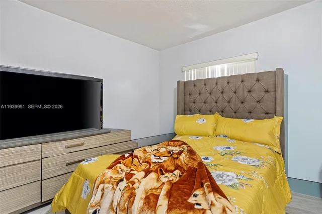 a bedroom with a bed and dresser