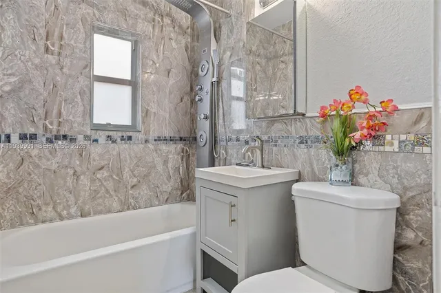 a bathroom with a sink toilet and bathtub
